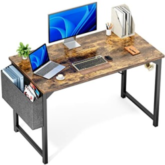 Modern office desk with computer monitors, laptop, keyboard, and organizer.