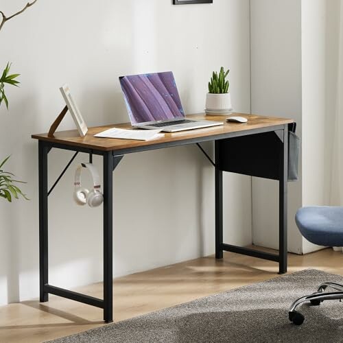 Modern wooden office desk with laptop and plants.