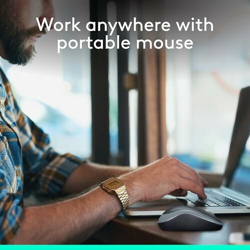 Person using a laptop with a portable mouse