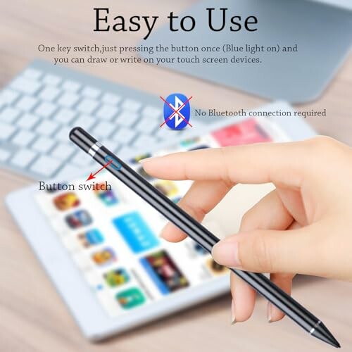 Hand holding a stylus pen with a tablet in the background.