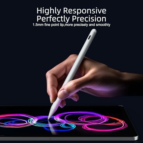 Hand using stylus on tablet with colorful design